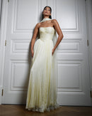 Draped in yellow chiffon silk, ruching that whispers elegance and grace